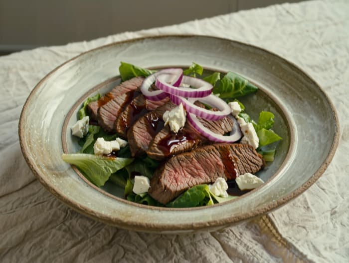 Steak Salad with Feta and Red Onion, plated and ready to serve