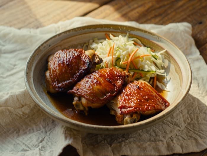 Broiled BBQ Chicken Thighs with Quick Slaw, plated and ready to serve